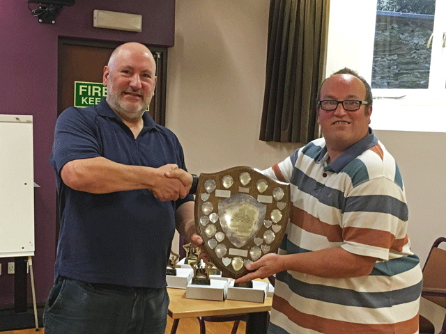 Ben Wilkinson presents the Division 2 trophy to Mike Hussey also representing Newton Abbot.